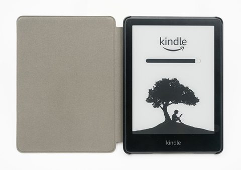 a kindle paperwhite e-reader in an olive green fabric cover, showing the kindle boot screen