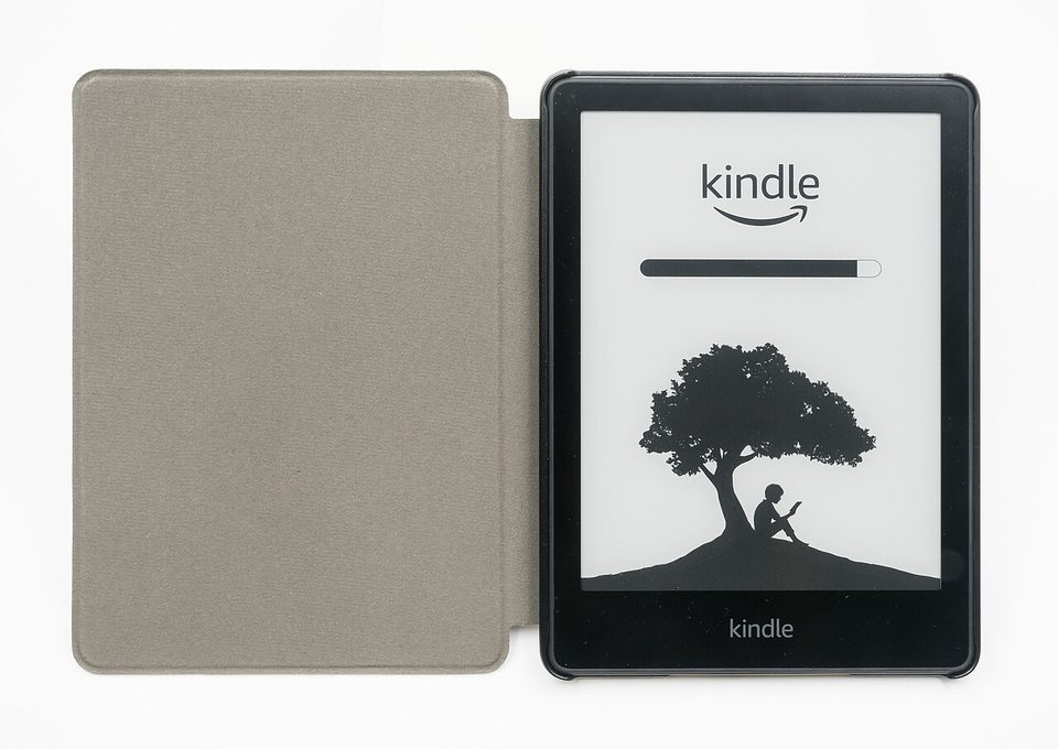 a kindle paperwhite e-reader in an olive green fabric cover, showing the kindle boot screen