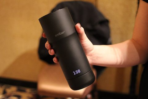 an ember smart mug sitting on its charging coaster