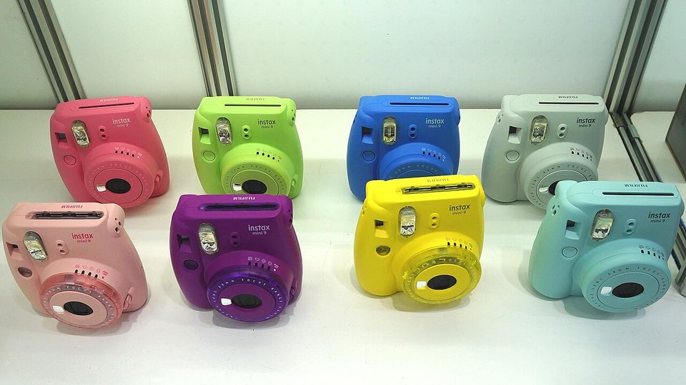 an instax mini instant camera in pastel blue on a table
