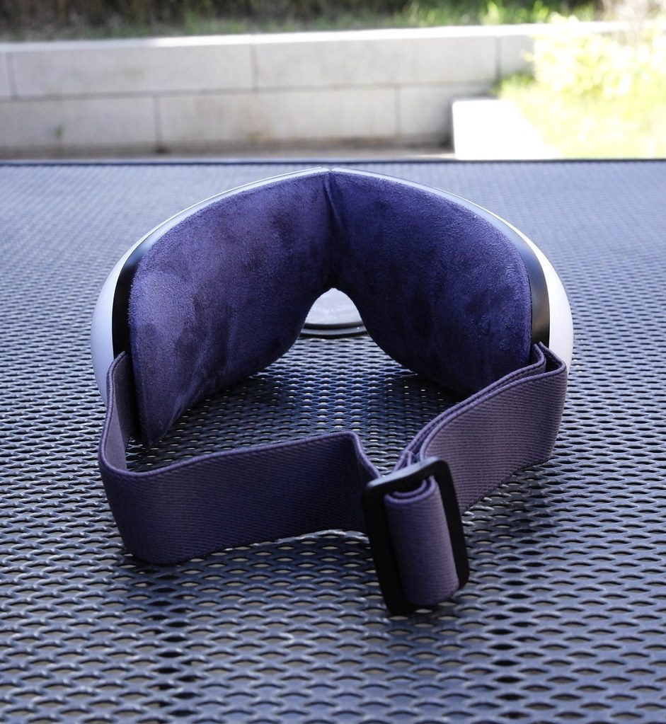 A dark eye massage mask device photographed up close