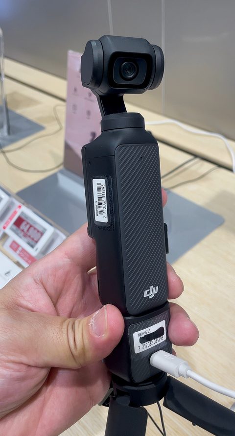 A DJI Osmo Pocket 3 gimbal camera standing upright