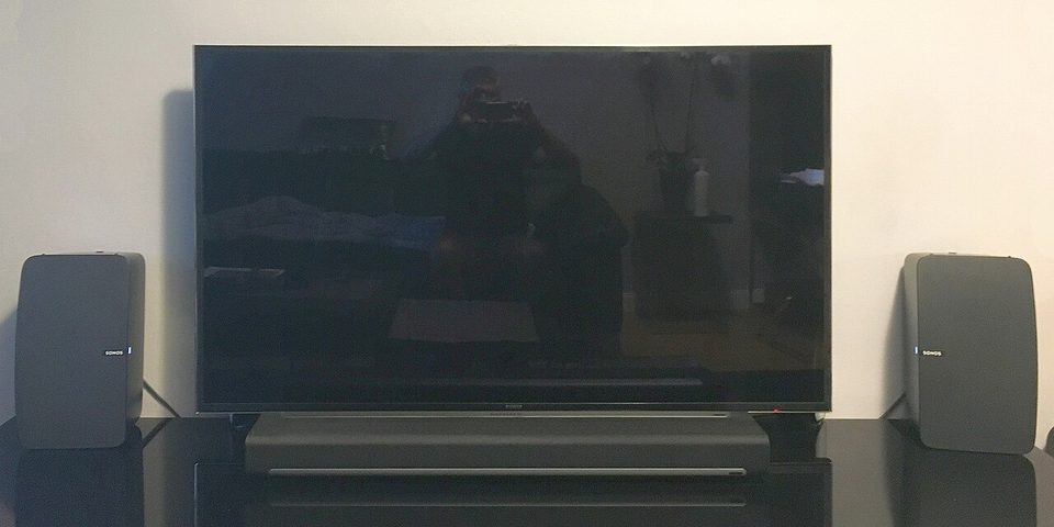 A living room TV setup with a Sonos soundbar under the screen