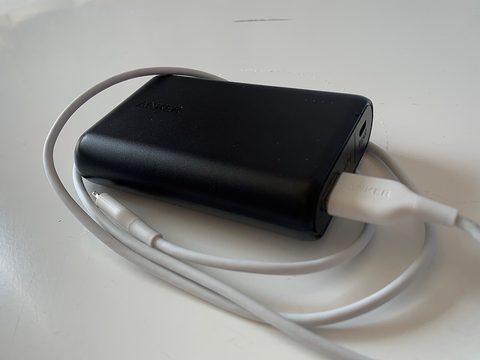An Anker power bank with a USB-C charging cable attached