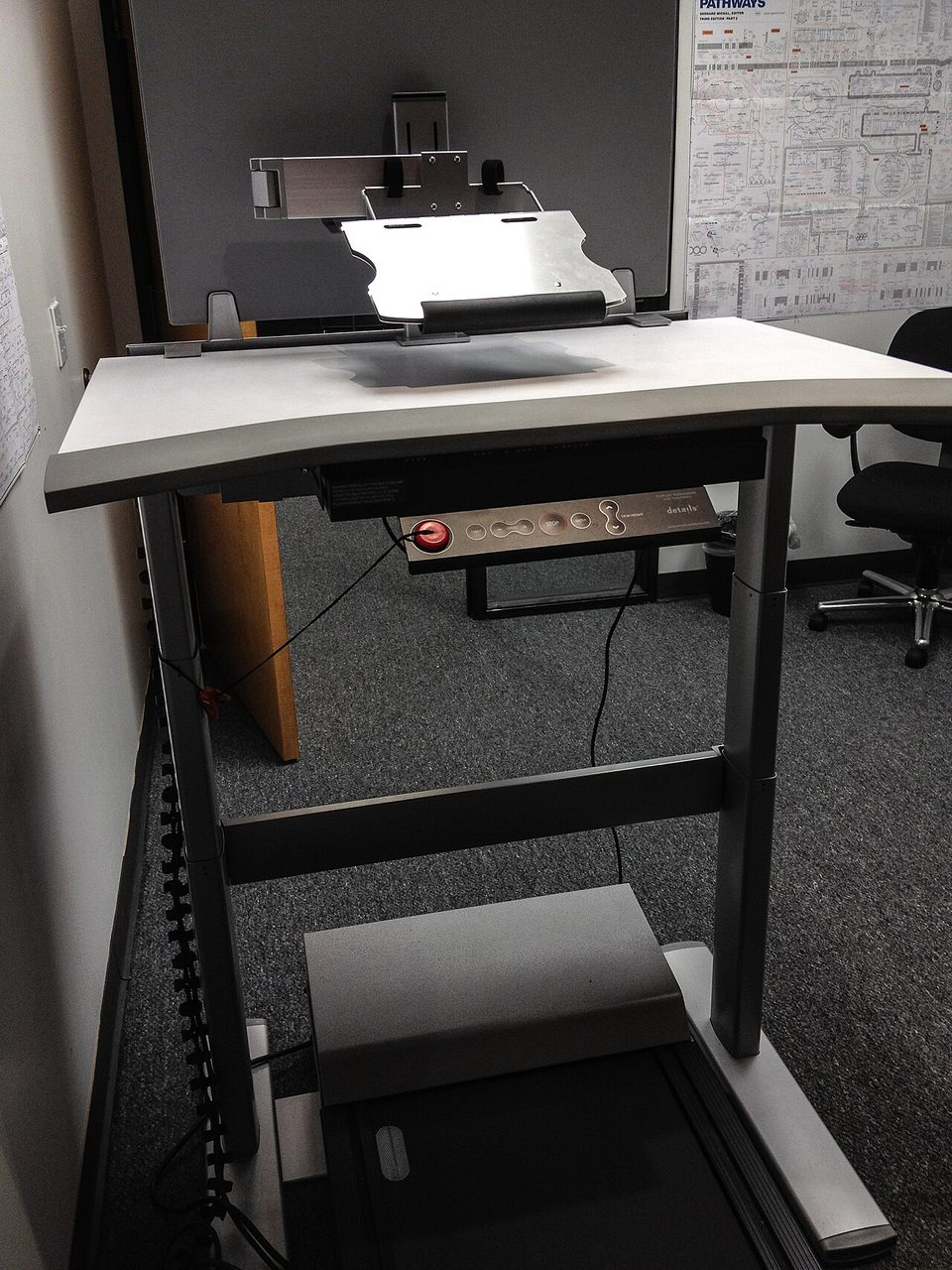a treadmill desk setup in an office, a full-size machine with a desk on top, not a walking pad