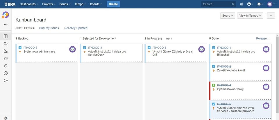 A Jira sprint board on a large office monitor, viewed from behind two colleagues