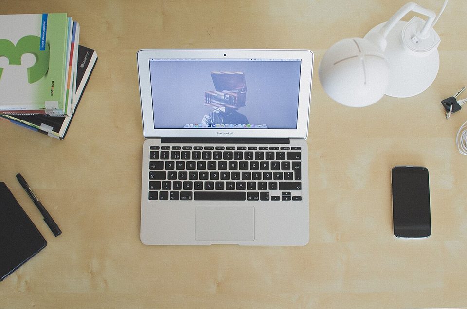 A laptop open on an empty desk