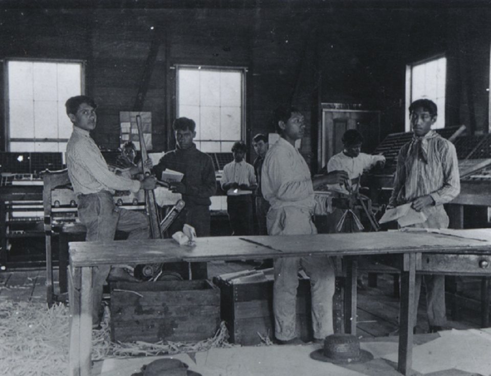 An old printing press in a small workshop, the equipment a publisher owns instead of rents