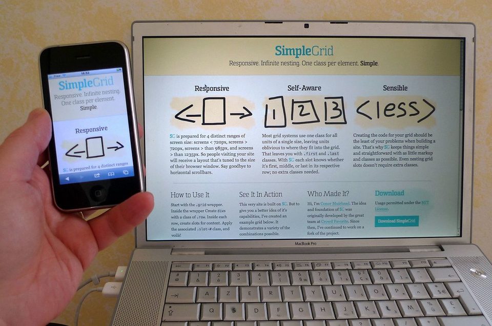 The same web page shown on a laptop and on a phone held beside it, its layout reflowed to fit the small screen