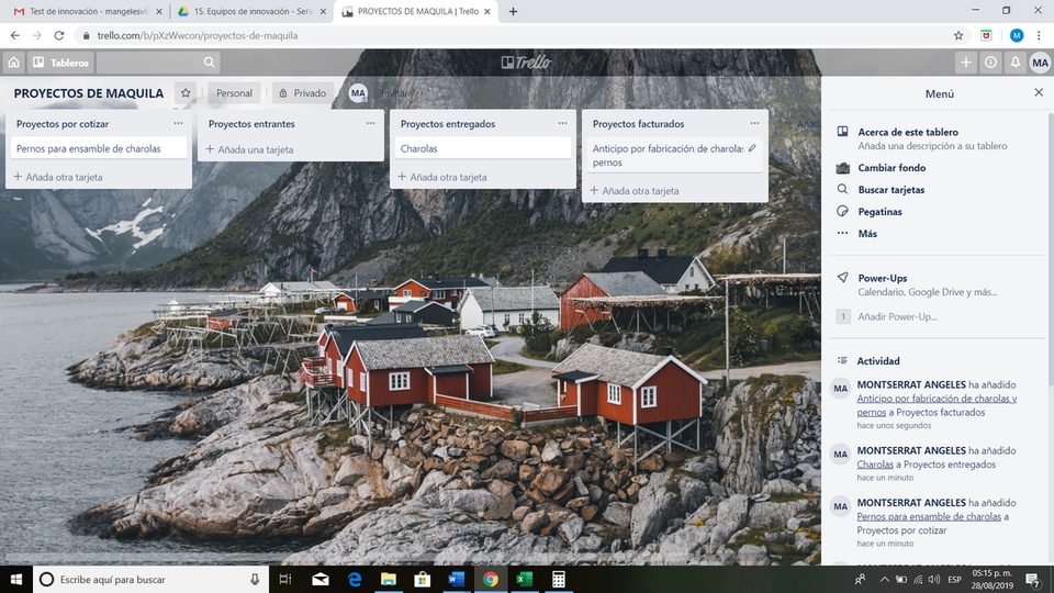 A Trello board on screen, lists of cards with labels and avatars