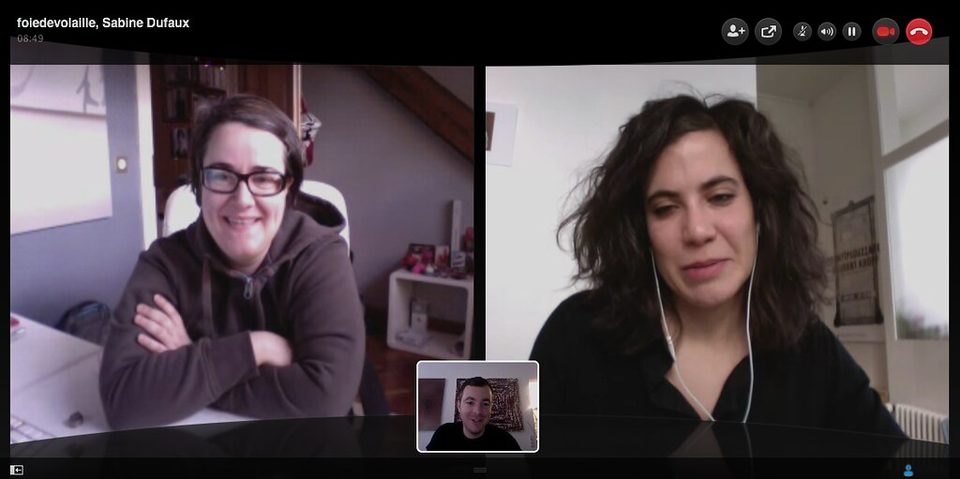 A laptop on a desk running a video call with several small faces, the on-camera format of a remote work session