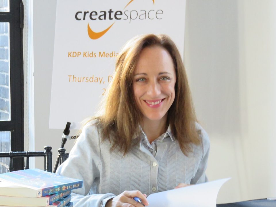 An author signing books at a Kindle Direct Publishing event in New York