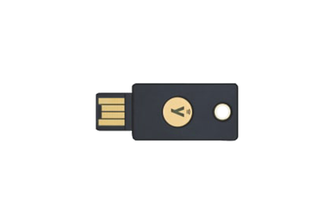 A flat grey USB security key with a gold contact and the YubiKey 5 NFC label on a dark background