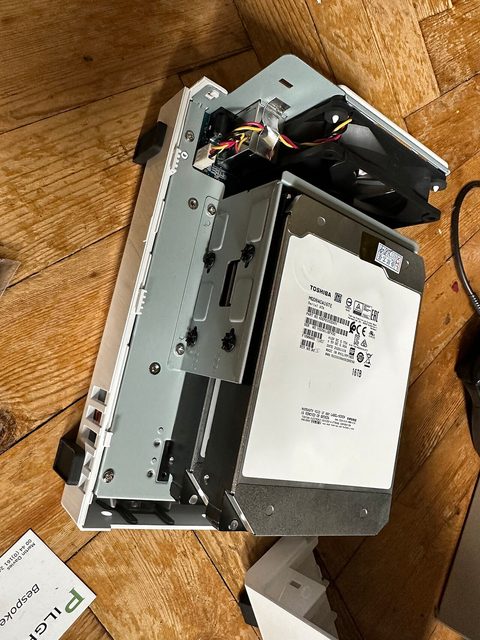 Two large hard drives beside a Synology NAS enclosure