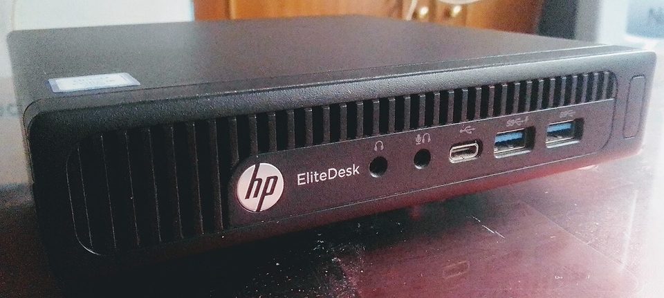 An HP EliteDesk 800 mini desktop PC photographed from the front