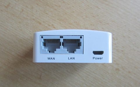 The port side of a small GL.iNet router with its Ethernet and USB jacks visible