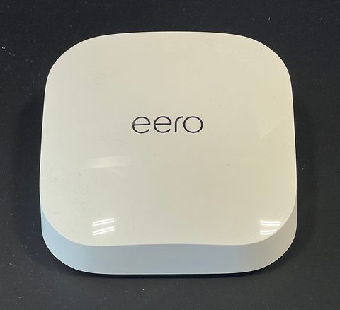 A white eero Pro 6E mesh node photographed from the front