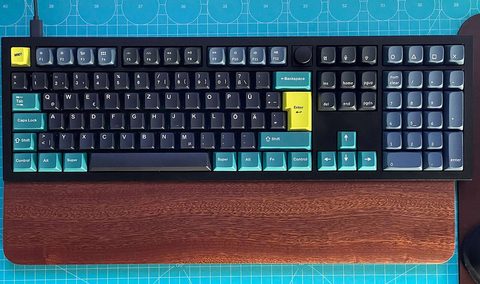 A Keychron Q-series aluminum mechanical keyboard on a desk, the Q6 shown; the Q3 shares the same gasket-mount design without the numpad