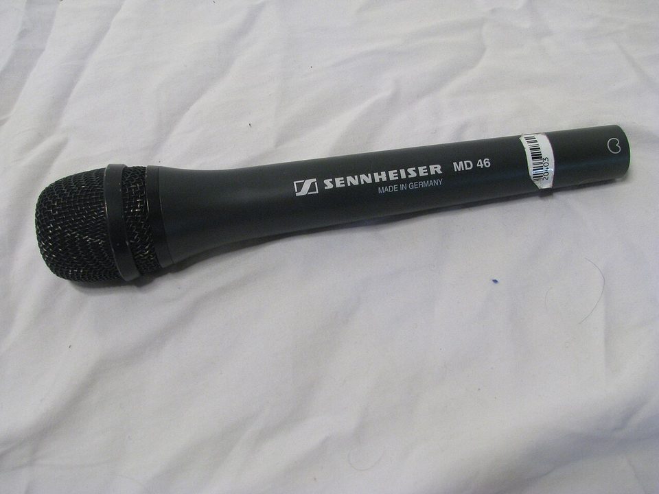 A handheld cardioid dynamic microphone, the same stick form factor as the ATR2100x-USB; a Sennheiser MD 46 shown