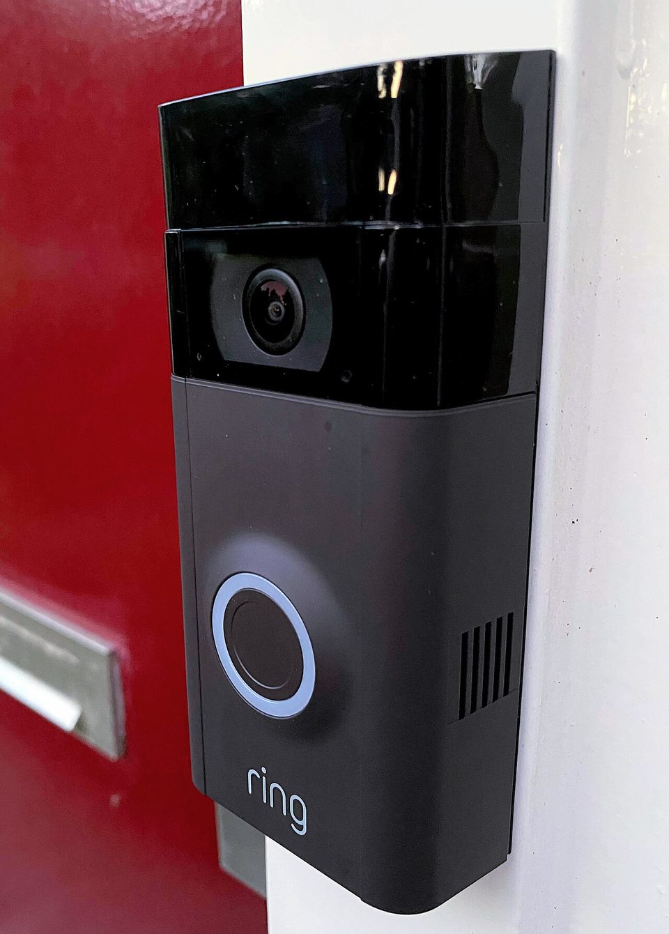 A Ring video doorbell mounted beside a front door