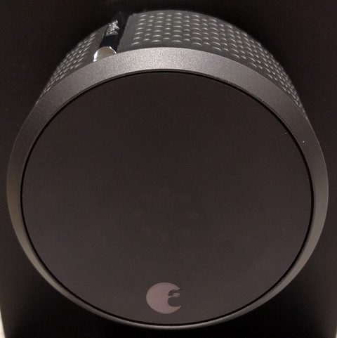 An August smart lock, the silver rounded disc that fits over the inside of a deadbolt