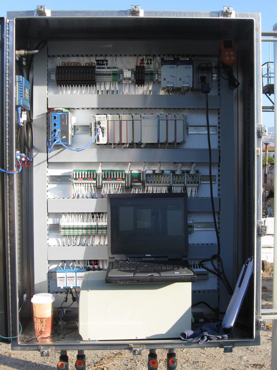An Allen-Bradley CompactLogix PLC mounted in an industrial control panel at an oilfield tank battery, shown because no freely licensed photo of the CLICK exists