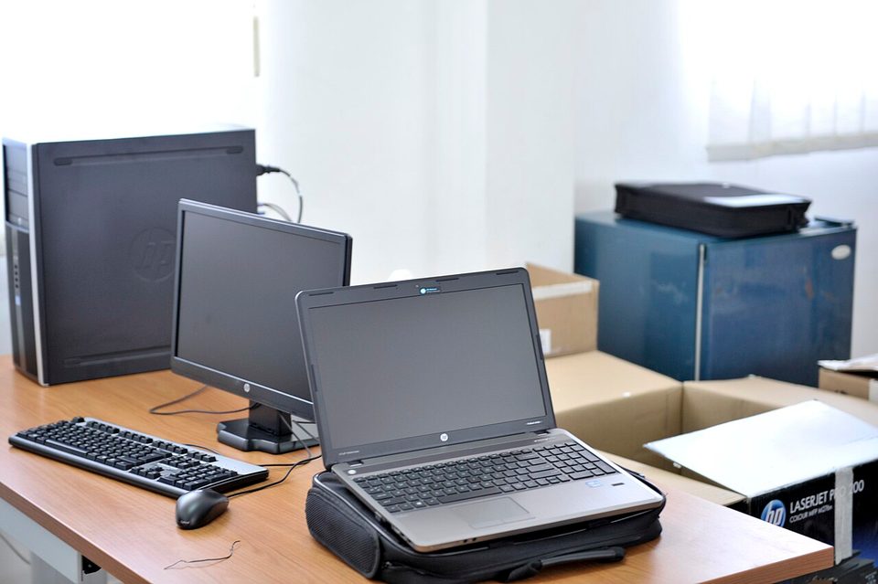 A laptop and desktop computer on an office desk